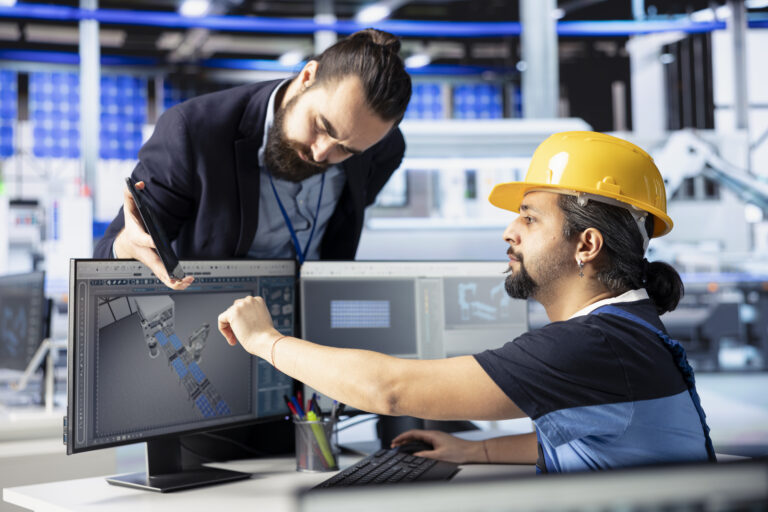 Team leader overseeing work done by man developing solar panel designs